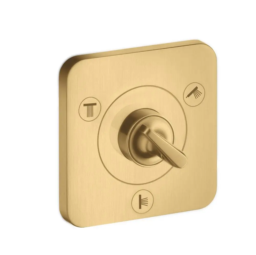 Wandmontiertes Ab- und Umstellventil von AXOR in gebürstetem Gold. Runde Bedienungseinheit mit Markierungen für unterschiedliche Wasserfunktionen.